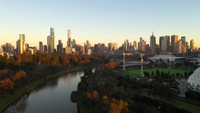 Melbourne skyline sunrise aerial vista with beautiful glowing Yarra River, Southbank and CBD cityscape