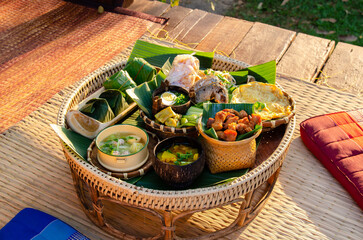 Khantoke, is a pedestal tray used as a small meal table by the Lanna people. A Set of traditional...