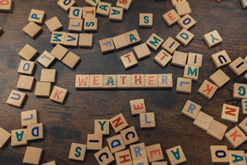 A word WEATHER made of aligned wooden alphabet letters climate concept . High quality photo