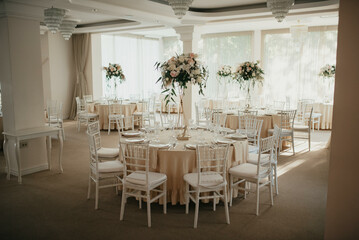 Decoration with fresh flowers, candles, light bulbs, garlands. Vintage style. Table setting for an event party or wedding reception. Event decorations.