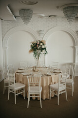 Decoration with fresh flowers, candles, light bulbs, garlands. Vintage style. Table setting for an event party or wedding reception. Event decorations.