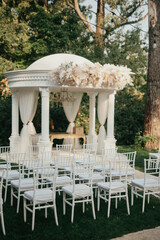 Decoration with fresh flowers, candles, light bulbs, garlands. Vintage style. Table setting for an event party or wedding reception. Event decorations.