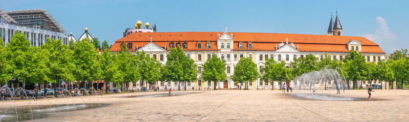 Panoramic view over major square with fountains in Magdeburg by Cathedral and Government Office, at sunny day and blue sky with people enjoying the day. - obrazy, fototapety, plakaty