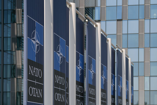 NATO logo flags in front of the headquarters building in Brussels, Belgium, 2022.