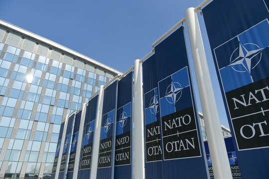 NATO logo flags in front of the headquarters building in Brussels, Belgium, 2022.