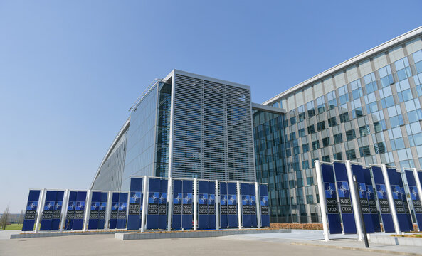 NATO Logo Flags In Front Of The Headquarters Building In Brussels, Belgium, 2022.