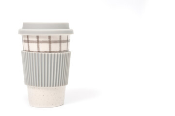 Checkered ceramic cup with rubber lid, shot against a white background.