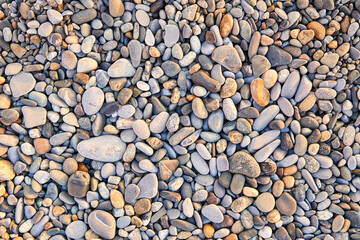 Colorful small pebbles or stone on sea pebble beach as background