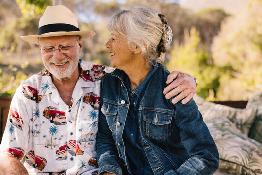 Happy senior couple smiling cheerfully at a spa resort
