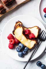Portion of homemade San Sebastian burnt cheesecake with berries for breakfast.