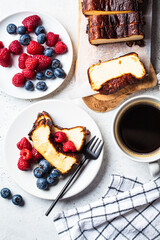 Portion of homemade San Sebastian burnt cheesecake with berries for breakfast.