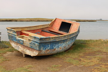 Stranded fishing red and blue boat