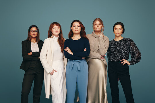 Five women of different ages standing together