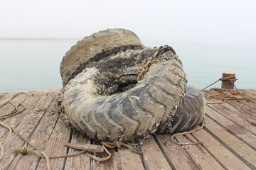 old tires on wooden deck pier