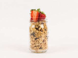 granola in bottle on white background