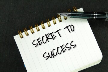 pen and notebook with the words SECRET TO SUCCESS