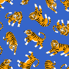 Vector seamless pattern with cute tigers on the blue background. Circus animal show. Fashionable fabric design.