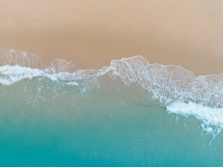 Fototapeta na wymiar Aerial top view of the summer beach blue wave in the tropical sea in summer background
