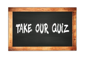 Obraz premium TAKE OUR QUIZ text written on wooden frame school blackboard.