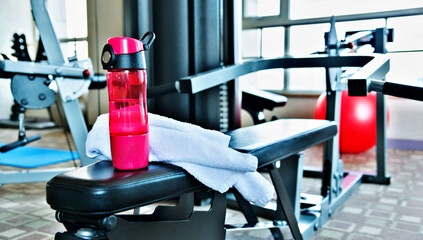 Towel and bottle of water in gym room
