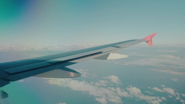 Airplane Airbus a320 approaching airport, flying over the ocean while using speed brakes to slow down.