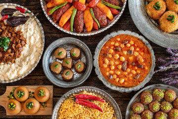Many kinds of food on the table. Local foods named izmir köfte , hünkar beğendi and etli nohut pilav