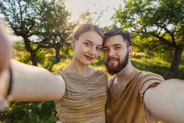 happy couple taking selfie on nature background