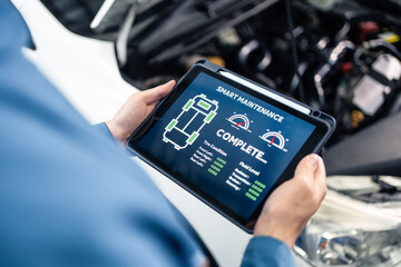 Close up of Automotive mechanic running diagnostics software on tablet