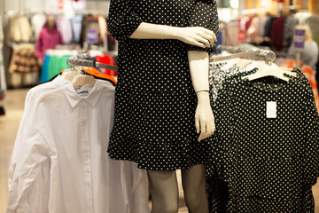 Department for the sale of women's clothing. Part of a manikin in a polka dot dress.