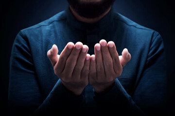 Muslim man praying on dark background