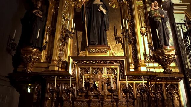 Monastery of Montserrat. Basilica of the Virgin Mary of Montserrat. Shrine of Catalonia statue of the Black Madonna. Altar part. Church sculptures and crucifixion.
