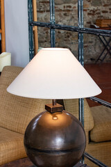 white lamp on a metal circle on the background of a mirror. Loft, Chalet, Scandinavian interior.