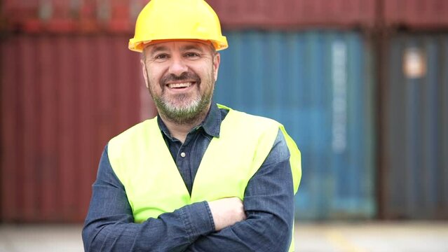 male container worker in port with helmet and reflective vest Caucasian man - concept of work in port cargo -