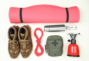 Set of traveler's equipment on white background, flat lay