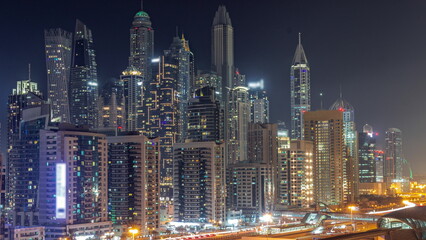 Fototapeta na wymiar Dubai marina tallest block of skyscrapers all night timelapse.