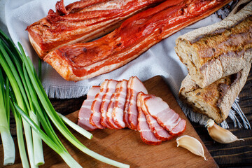 pork balyk on a dark background sliced on a dark background, concept for a farm shop 