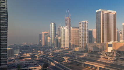 Naklejka na ściany i meble Dubai Marina skyscrapers and Sheikh Zayed road with metro railway aerial timelapse, United Arab Emirates