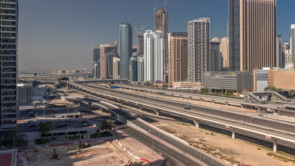 Naklejka na ściany i meble Dubai Marina skyscrapers and Sheikh Zayed road with metro railway aerial all day timelapse, United Arab Emirates