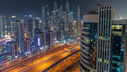 Fototapeta na wymiar Dubai marina tallest block of skyscrapers night timelapse.