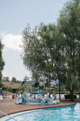 Coziness and style. Modern event design. Lounge zone and european traditional wedding ceremony decoration outdoors in the restaurant before the reception.