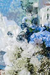 Coziness and style. Modern event design. Lounge zone and european traditional wedding ceremony decoration outdoors in the restaurant before the reception.