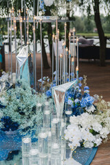 Coziness and style. Modern event design. Lounge zone and european traditional wedding ceremony decoration outdoors in the restaurant before the reception.