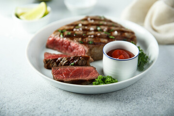 Grilled beef steak with tomato sauce