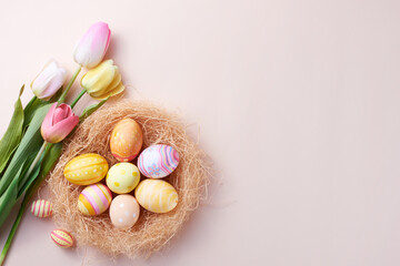 Happy Easter day colorful eggs in nest and flower on paper background with copy space