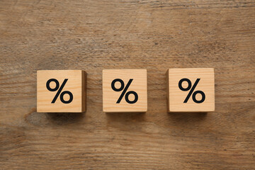 Wooden cubes with percent signs on table, flat lay