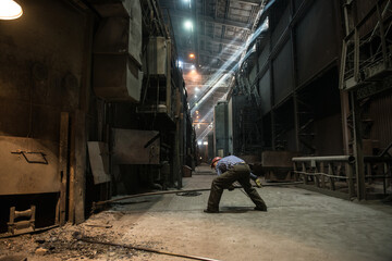 Steelworker at work near the arc furnace - 495402076