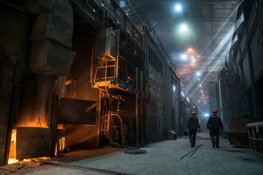 Steelworkers near the working arc furnace