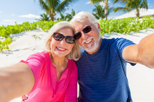 Portrait of loving retired Caucasian couple on beach