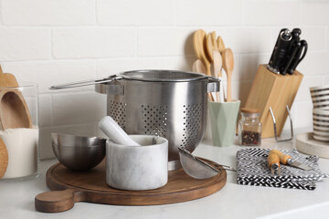 Different cooking utensils on countertop in kitchen