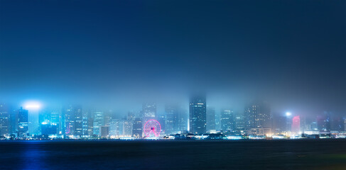 Fototapeta na wymiar Panorama of Victoria harbor of Hong Kong city in fog